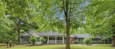 Nestled among lush greenery, this spacious home offers abundant outdoor space for relaxation and entertainment.