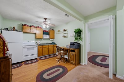 Cottage features a covered front porch, an open living area, kitchenette, private bedroom, and full bath. A versatile space that offers flexibility and functionality, perfect for hosting guests, working from home, or creating a studio or hobby space.