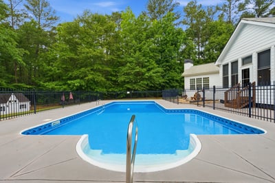 Discover a refreshing in-ground pool surrounded by spacious decking, perfect for outdoor relaxation and entertaining.