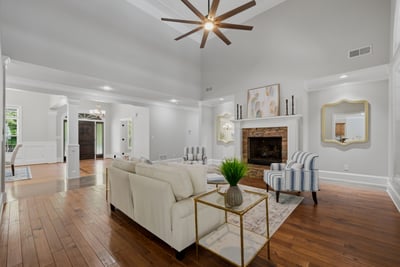 Spacious living area with soaring ceilings and natural light throughout.