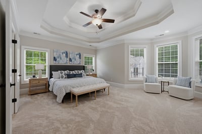 Spacious primary bedroom features an incredible trey ceiling, abundant natural light, and sitting area.