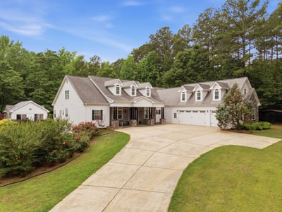 Discover this luxury home with inviting outdoor spaces, a pool, and beautiful landscaping .