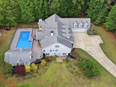 Discover this luxury home with inviting outdoor spaces, a pool, and beautiful landscaping .