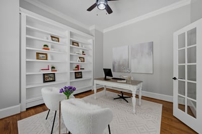 Bright and airy office space featuring built-in shelves.