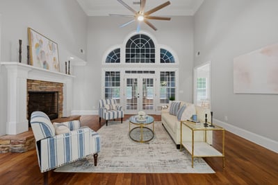 Spacious living area with soaring ceilings and natural light throughout.