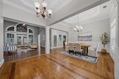 Spacious open-concept living area featuring abundant natural light and refined detailing, perfect for gatherings and entertaining.