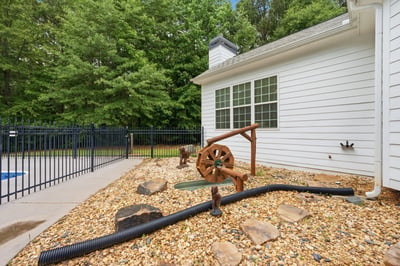 This well-maintained property features a unique outdoor space with a decorative water feature and landscaped rocks.