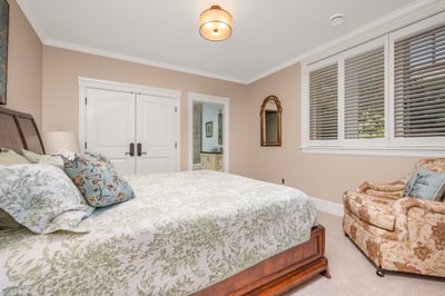 An inviting fourth bedroom featuring ample natural light and an en-suite bathroom for convenience.