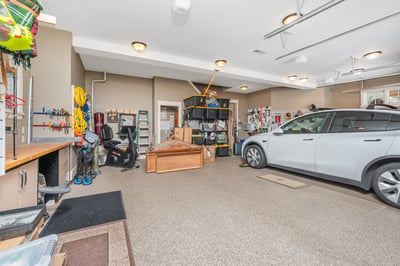 Spacious garage with ample storage, versatile workspaces, and room for multiple vehicles and projects.