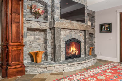 Cozy living space featuring a stunning stone fireplace, perfect for gatherings and relaxation.