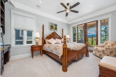 Spacious bedroom with ample natural light, and picturesque views from the private balcony.