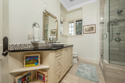 Modern bathroom featuring a spacious walk-in shower, sleek vanity, and convenient storage for essentials. Beautiful views from the windows.