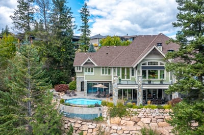 Discover this spacious home featuring a private pool, expansive outdoor space, and stunning natural surroundings. This rear photo shows off the Craftsman architecture. Hope painted the summer of 2024.