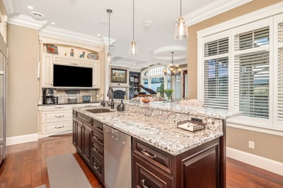 Discover a well-designed kitchen featuring a large granite island, Miele, Wolf, and Sub-Zero appliances, and ample natural light and golf course views. The abundant cabinets have room for everything you will ever need for entertaining.