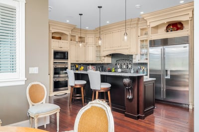 This inviting kitchen features custom cabinetry, a spacious island, and high-end appliances for culinary enthusiasts.