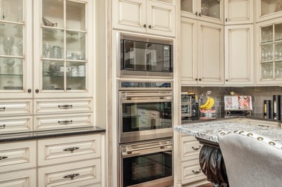 This gourmet kitchen features high-end appliances, custom cabinetry, and a spacious granite counter for entertaining.