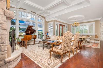 Spacious living room featuring a grand piano, stunning views, and abundant natural light throughout.