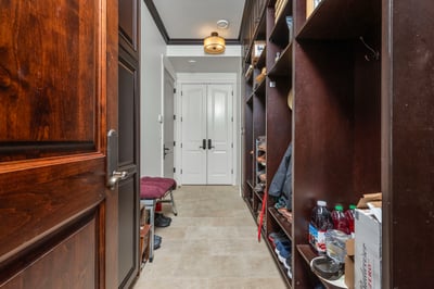 Spacious entryway features custom shelving and ample storage, offering a practical yet welcoming first impression.
