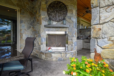 Discover a unique outdoor space featuring a stone fireplace, perfect for gatherings and relaxation.