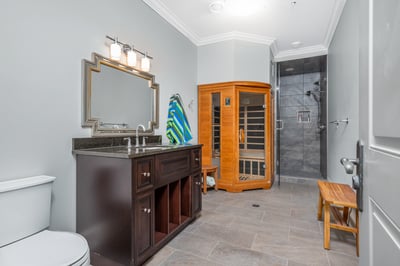Modern bathroom featuring a spacious layout, sleek fixtures, a sauna, and a luxurious walk-in shower.