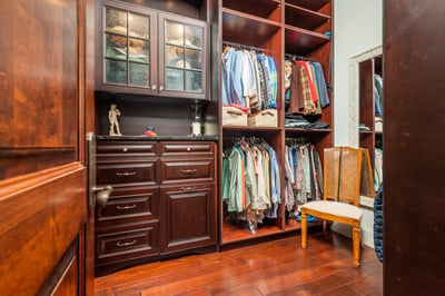 Discover a spacious walk-in closet featuring custom cabinetry and ample storage for all your wardrobe needs.