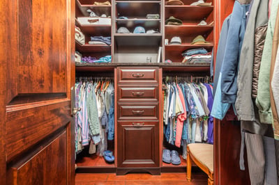 Spacious custom closet features organized shelving and ample hanging space for a stylish wardrobe.