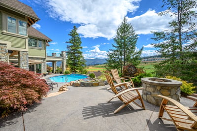 Discover a spacious outdoor retreat featuring a pool, fire pit, and stunning mountain views.