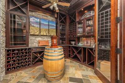 Discover a sophisticated wine cellar featuring custom racks and a stunning mural, perfect for entertaining.