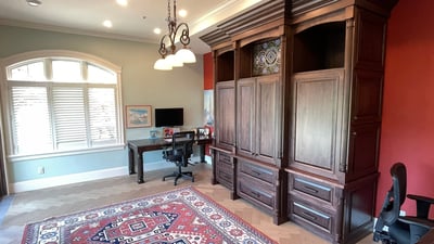 Spacious home office featuring built-in cabinetry, a dedicated workspace, and ample natural light for productivity.