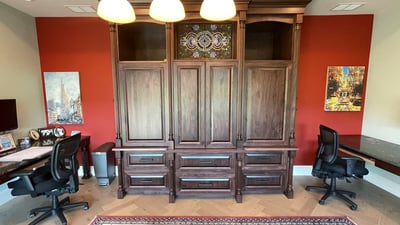 Spacious home office featuring custom cabinetry and dual desks, ideal for productivity and organization.