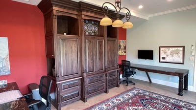 Spacious office area featuring custom cabinetry, modern workstations, and vibrant accent walls for inspiration.
