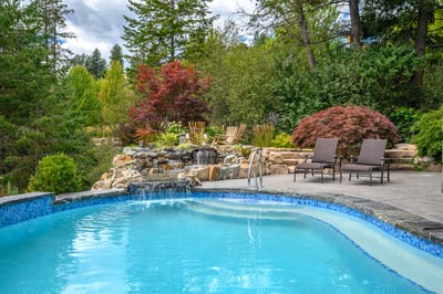 Relax by the inviting pool surrounded by lush greenery and tranquil water features. Perfect for unwinding.