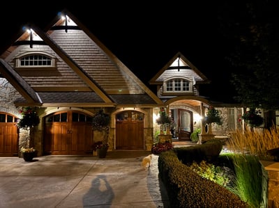 This inviting home features a unique Craftsman architectural design and beautifully landscaped (tended by the strada) exterior, illuminated at night.