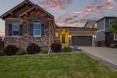 Beautifully crafted home featuring a unique stone facade and inviting outdoor space, perfect for entertaining.