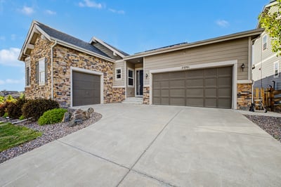 Discover modern living in this spacious home, featuring a dual garage and attractive stone accents.