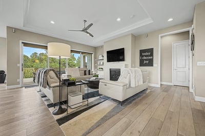 Bright and inviting living room with modern finishes, large windows, and a cozy fireplace, perfect for gatherings.