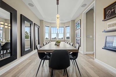 Discover a spacious dining area featuring large windows, modern decor, and ample natural light for gatherings.