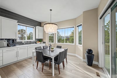 Bright and airy kitchen with large windows, modern fixtures, and a spacious dining area for gatherings.