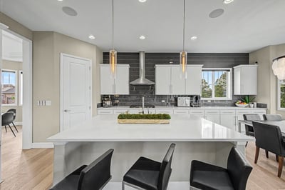 Contemporary kitchen featuring sleek cabinetry, a spacious island, and high-end stainless steel appliances for modern living.