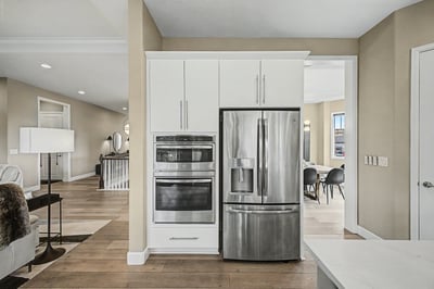 Modern kitchen with stainless steel appliances, open layout, and seamless flow into adjacent living areas.
