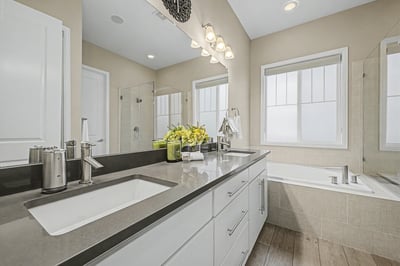 Bright and airy bathroom featuring modern fixtures, dual sinks, and ample natural light. Perfect for relaxation.