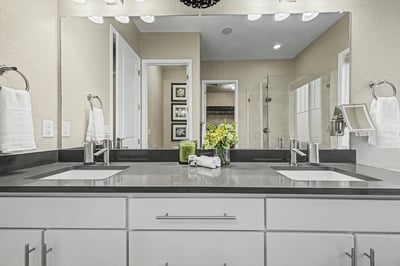 Modern bathroom featuring dual sinks, sleek countertops, and ample natural light for a refreshing atmosphere.
