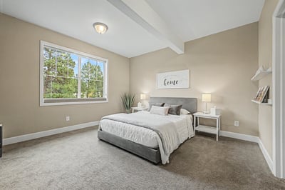 Spacious bedroom featuring large windows, neutral tones, and versatile decor options for personalized touches.