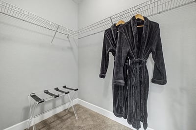 Spacious walk-in closet featuring ample storage, perfect for organizing your wardrobe and accessories.