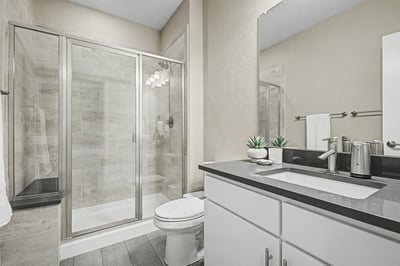 Modern bathroom featuring a sleek design with glass shower enclosure and contemporary fixtures.