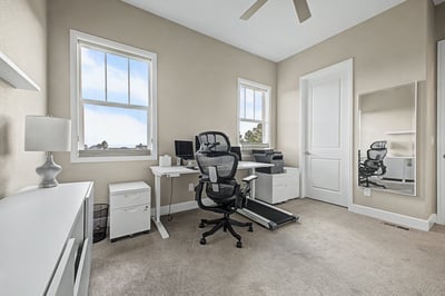 Bright and airy home office featuring large windows, modern furnishings, and ample storage for productivity.
