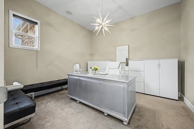 Bright office space featuring contemporary furnishings, ample storage, and a unique pendant light for inspiration.