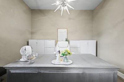 Bright home office featuring a spacious desk, ample storage, and modern fixtures for creative productivity.