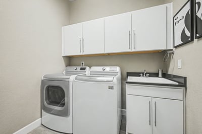 Bright laundry room featuring modern appliances and ample storage, perfect for efficient household management.