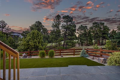 Discover captivating sunset views and lush greenery from this inviting outdoor living space.